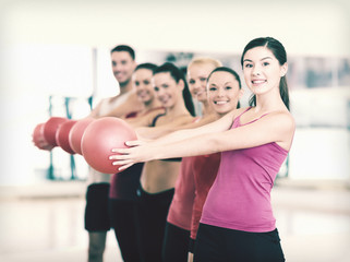 Fototapeta na wymiar group of smiling people working out with ball