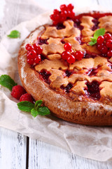 Tasty cake with berries on table close-up