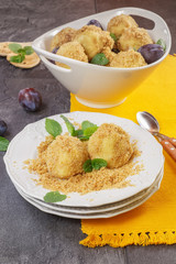 Plum dumplings covered with breadcrumb and sprinkled with sugar