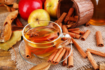 Composition of  apple cider with cinnamon sticks, fresh apples