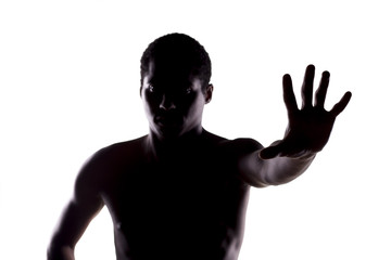 silhouette of African man on a white, showing stop hand