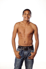 Fototapeta premium half-naked young dark-skinned man standing on white background