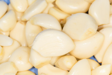 Closeup of peeled cloves of garlic, background