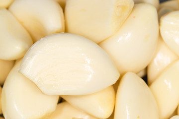 Closeup of peeled cloves of garlic, background