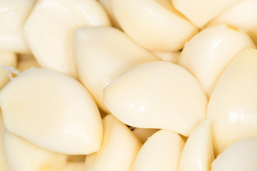 Closeup of peeled cloves of garlic, background