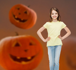 smiling girl over pumpkins background