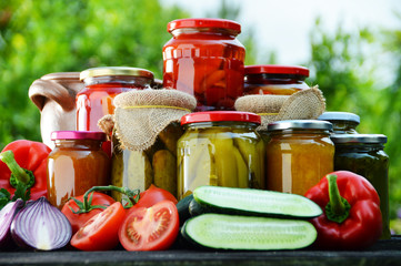 Jars of pickled vegetables in the garden. Marinated food