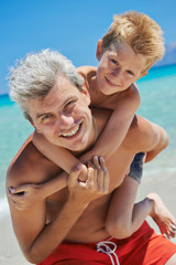 Man with boy at sea beach