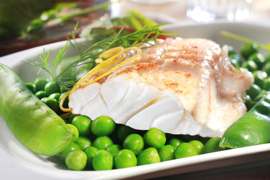 Healthy grilled fish steak with peas