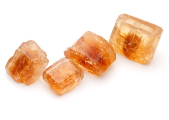 Brown caramelized lump cane sugar cube isolated on white backgro