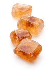 Brown caramelized lump cane sugar cube isolated on white backgro
