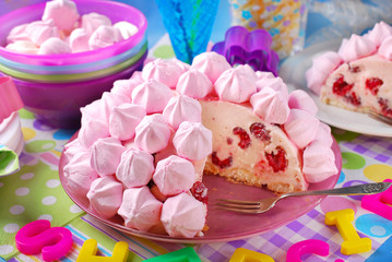 Fototapeta na wymiar birthday cake with pink meringues and raspberries