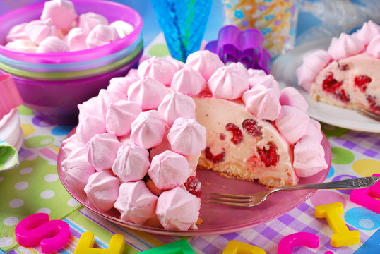 birthday cake with pink meringues and raspberries