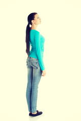 Young casual woman from behind looking up