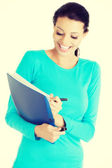 Happy student woman with notebook