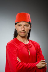 Funny man in red dress wearing fez hat