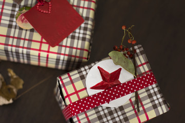 Fototapeta na wymiar presents wrapped in checkered paper and brown ribbon with label