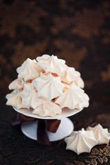 Meringue cookies on cake stand, selective focus