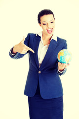 Young businesswoman holding globe