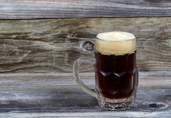 Draft Stout Beer in Glass Stein on Rustic Wood