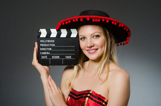 Funny mexican woman with sombrero and movie clapboard