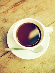 cup of coffee on wood desk