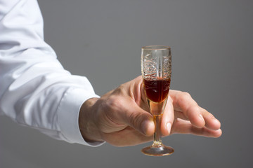 Man's hand on a glass of aperitif.