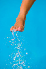 Fototapeta premium girl's beauty legs in the pool making splashes
