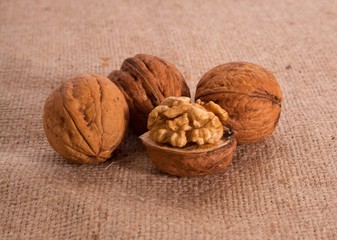 Walnut kernels and whole walnuts on texture background