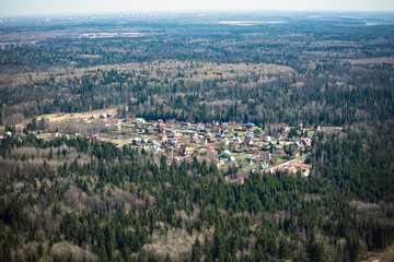 Russian forest during spring and a small settlement