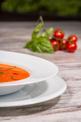 Picture of cold tasty tomato soup gazpacho with species on the w