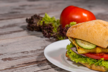 Close-up picture of vegetarian sandwich with tofu, tomatoes, sal