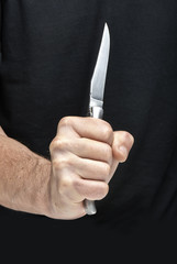 Man with a knife in a hand. Closeup