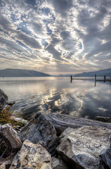 Boulders, lake, and cloudy sky.