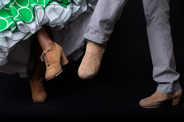 Feet detail of flamenco dancers on black background. - obrazy, fototapety, plakaty