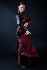 Fototapeta na wymiar Young flamenco dancer in beautiful dress on black background.