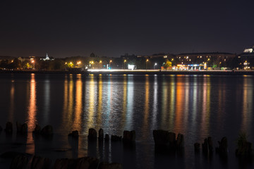 summer night city light reflections over water