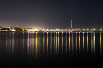 summer night city light reflections over water