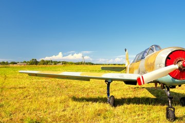 Old russian airplane on green grass
