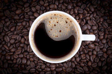 Top View of a Cup of coffee on coffee beans background