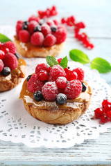 Sweet cakes with berries on table close-up