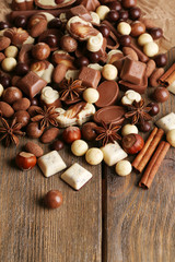 Different kinds of chocolates on wooden table close-up