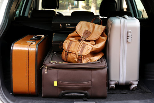 Suitcases and bags in trunk of car ready to depart for holidays