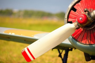 View on propeller on old russian airplane on green grass