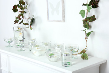 Different objects on white shelf in living room