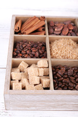 Wooden box with set of coffee and cocoa beans, sugar cubes,