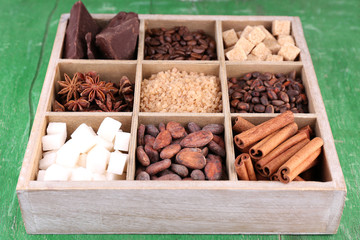 Wooden box with set of coffee and cocoa beans, sugar cubes,