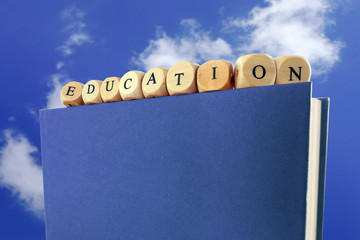 Education message written with wooden blocks on the top of a boo