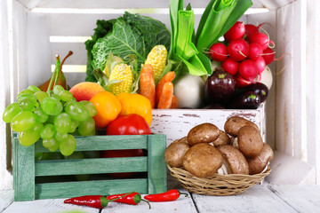 Vegetables in wooden boxes on white wooden box background