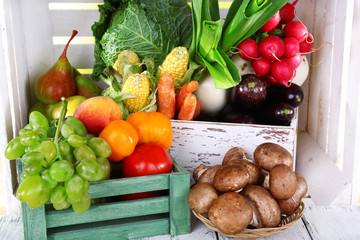 Vegetables in wooden boxes on white wooden box background